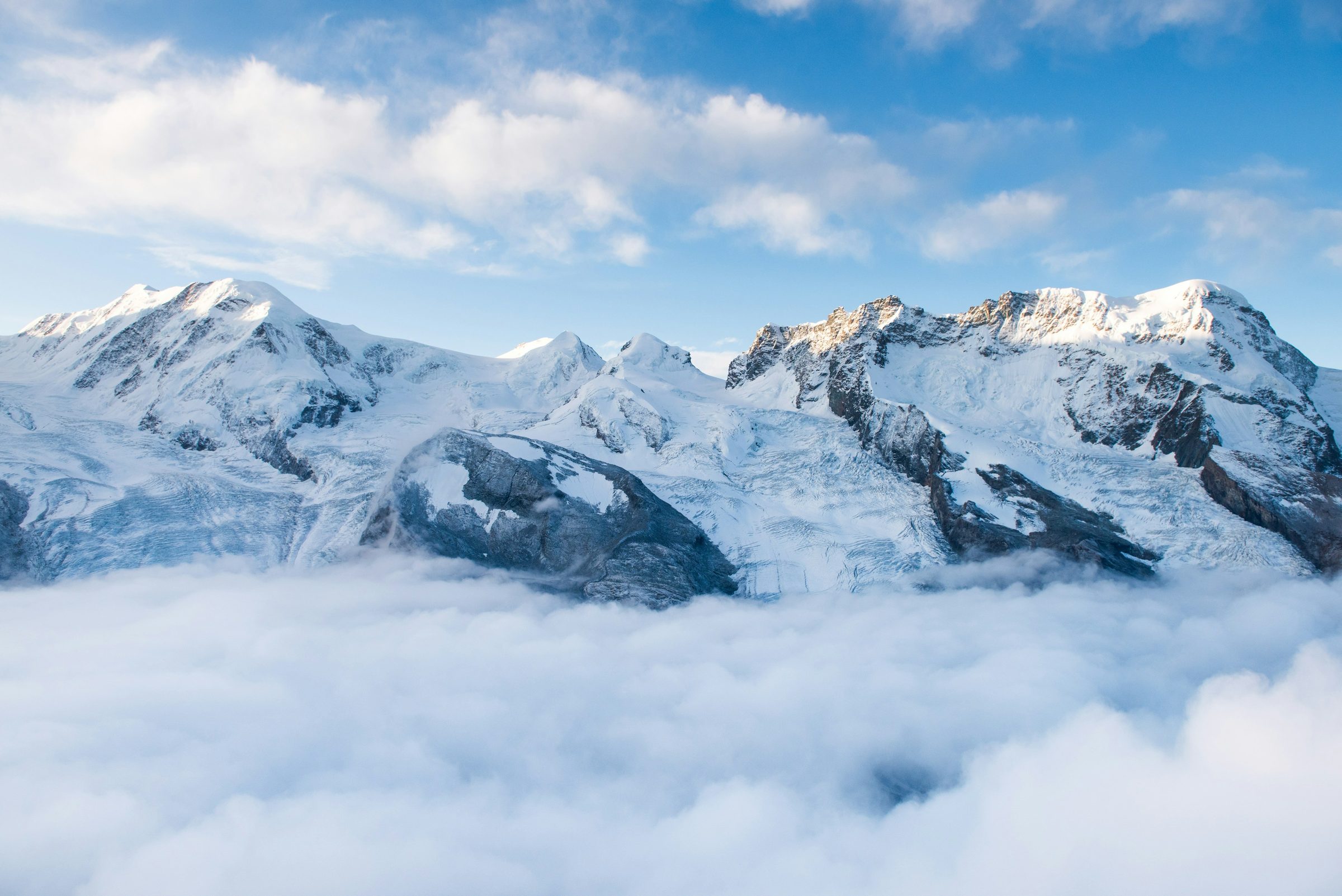 Snow-covered alpine peaks above a sea of cloud